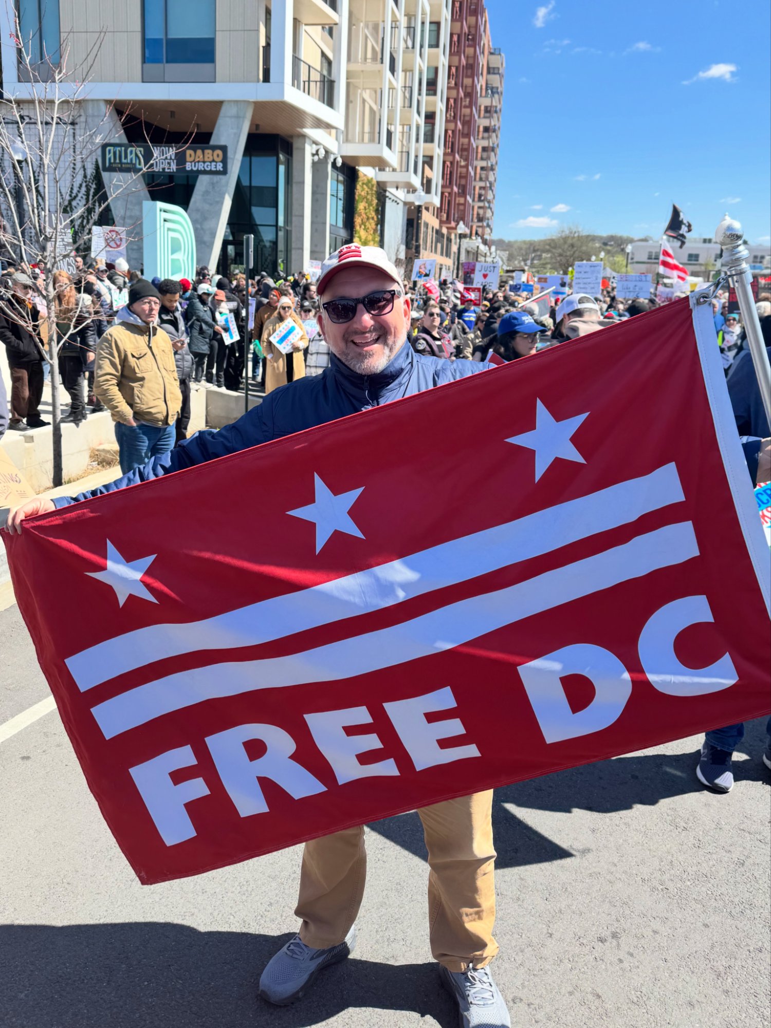 Mike Panetta holding Free DC flag at rally